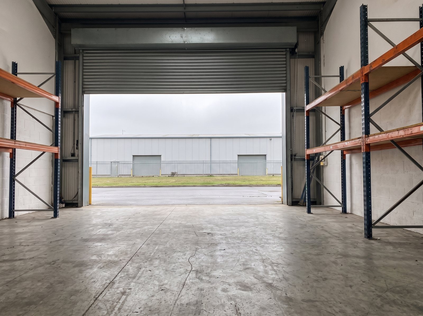 Industrial unit full of pallets, racking and stock, after